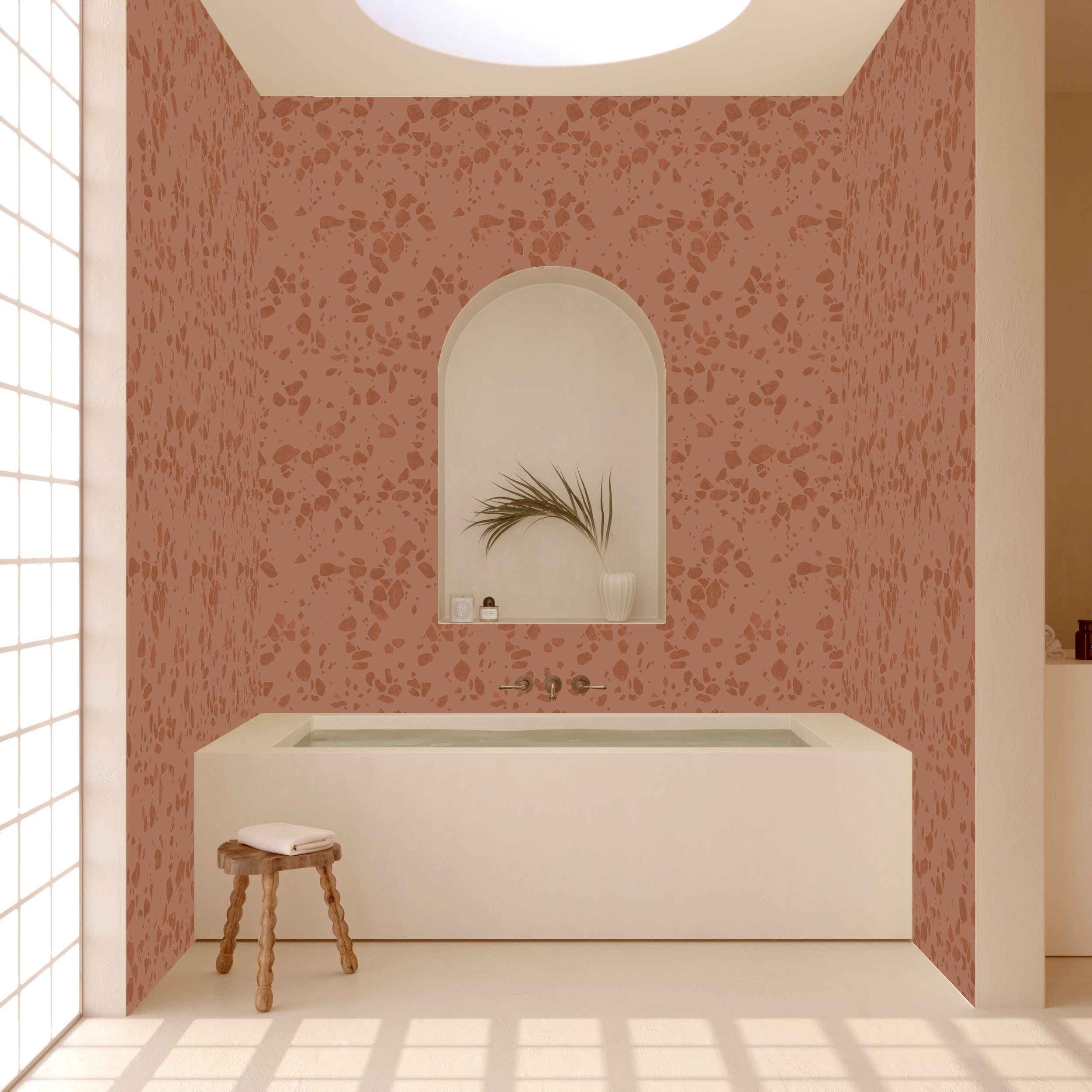 Bathroom with pink floral wallpaper, white bathtub, and wooden stool from drop it MODERN.