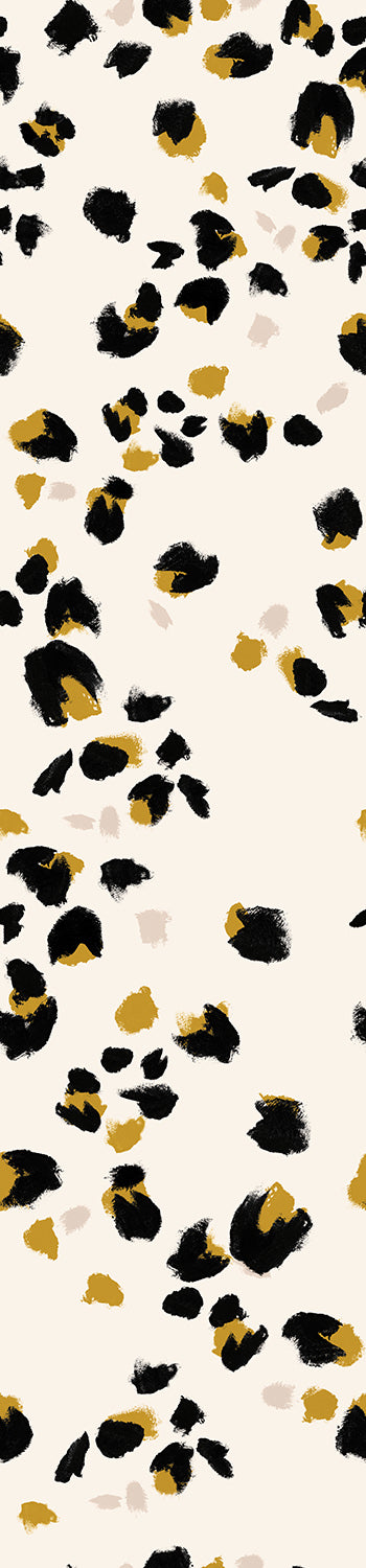 A roll of wallpaper featuring a animal print with beige, black, and yellow colors on a creme background from drop it MODERN.