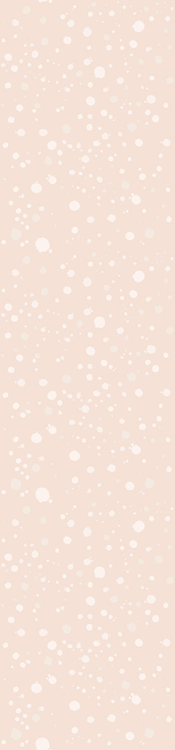 A roll of blush pink wallpaper with a pattern of white ink drops from drop it MODERN.