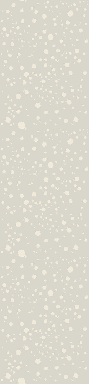 A roll of wallpaper with a geometric dot pattern in a pistachio green color from drop it MODERN.