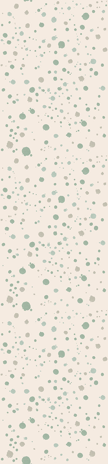 A roll of wallpaper featuring a dotted pattern with various shades of green ink drops on a beige background from drop it MODERN.