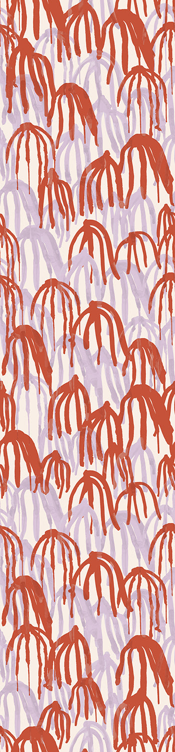 A rolled piece of wallpaper showing a pattern with abstract red and purple shapes on a white background from drop it MODERN.